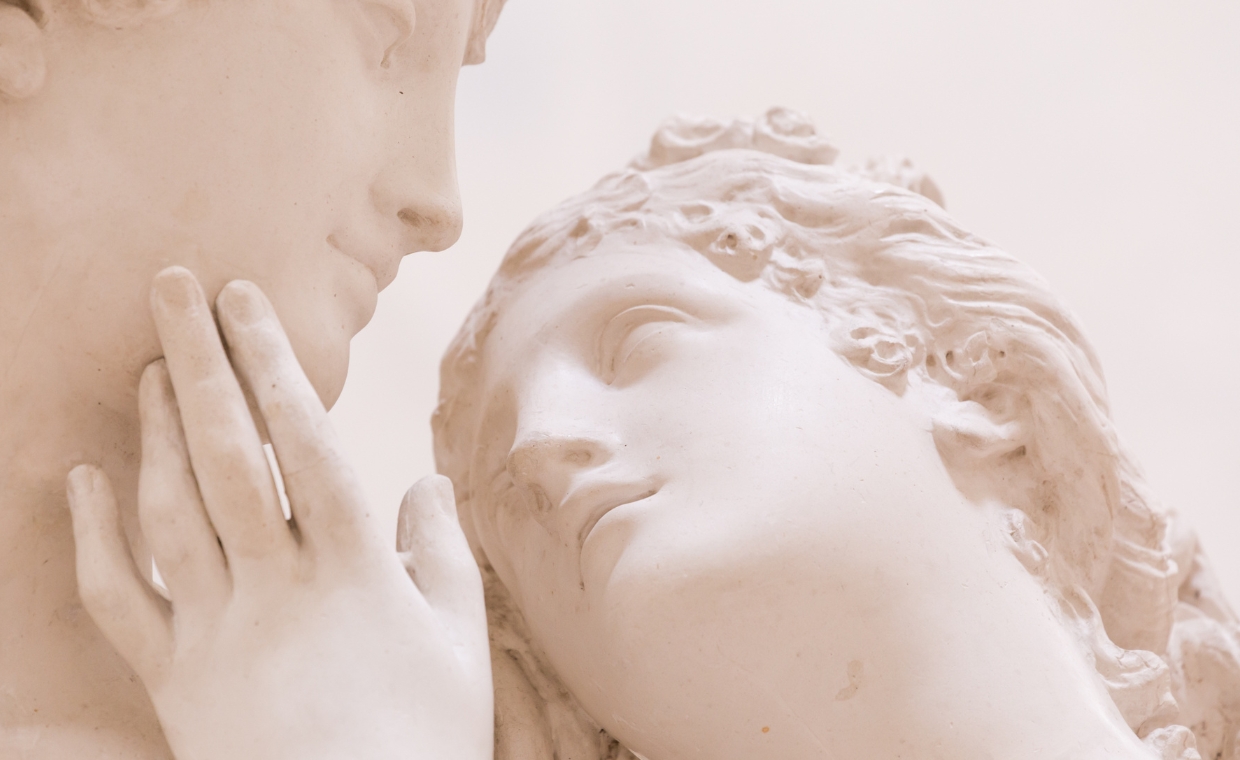 Marble sculpture of a pair of lovers with woman's hand on man's face