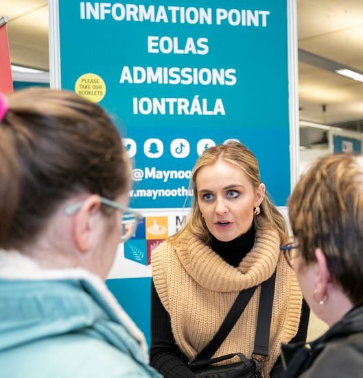 Image of Admissions Office staff talking to open day visitor at the Admissions welcome stand.