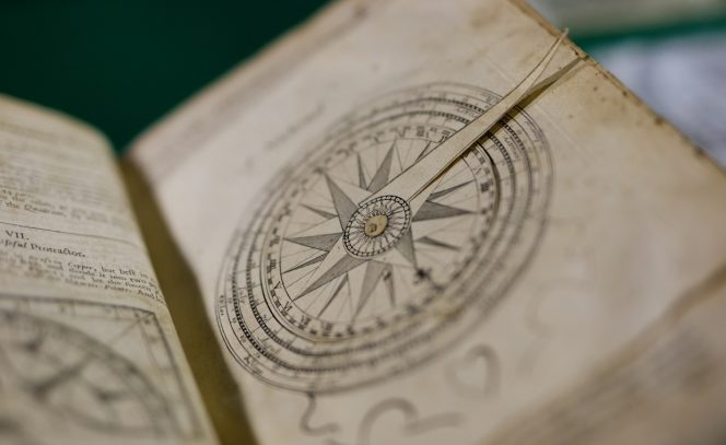 Page of a book showing a compass