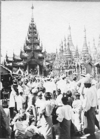 A black & white photograph of devotees outside a temple in Rangoon in the early 1900s.  