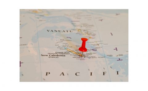 Map of Pacific showing island of New Caledonia with a red pin in it
