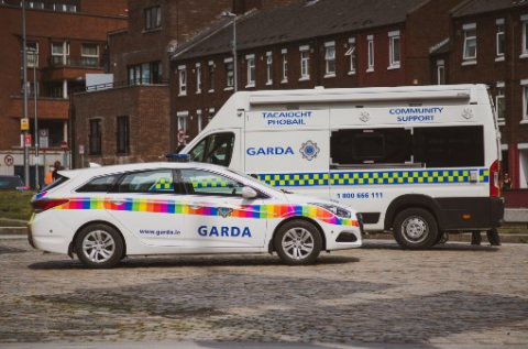 A garda car and van parked in front of some houses