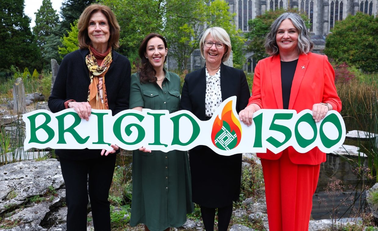 Four women standing in a row holding a banner that says Brigid 1500