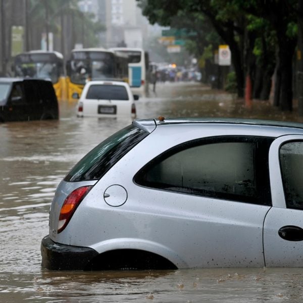 Silver car surrounded by flood waters