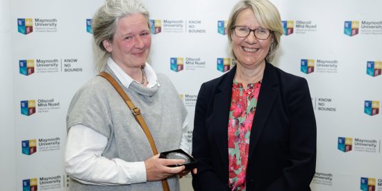 Dr Mette Lebech standing to the left of Prof. Eeva Leinonen, accepting an award celebrating her 25th year at MU. 