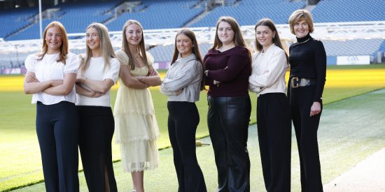 Seven women standing beside the pitch in Croke Park