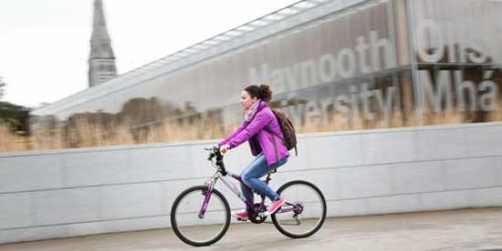 Communications & Marketing - Library sign bike female cyclist - Maynooth University