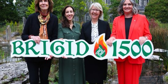 Four women standing in a row holding a banner that says Brigid 1500