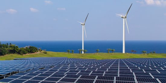 A view of the coast, with 2 wind mills and a solar panel farm