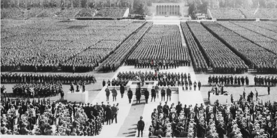 Nazi rally showing rows of people lined up before a podium