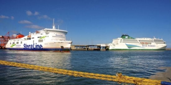 2 large passenger ships, white in colour on the water. Blue skies.