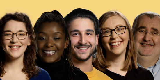 5 people in a row smiling into camera, the background is yellow