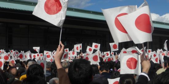 People waving Japanese flags