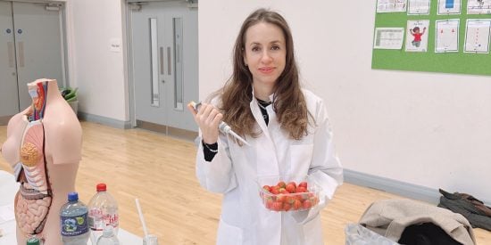 Dr. Özlem Sarikaya Bayram  holding a pippette while extracting DNA from Strawberries