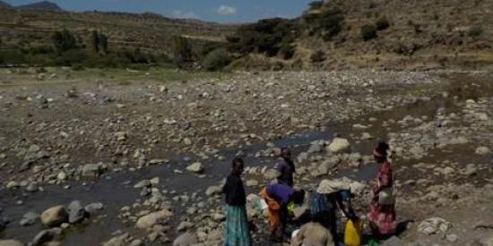Outskirts of Mekelle, Ethiopia.  Women collecting water for drinking from a drying stream.
