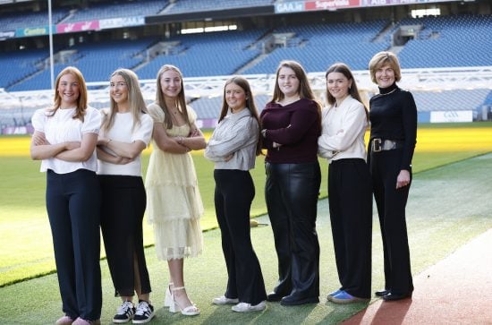 Seven women standing beside the pitch in Croke Park