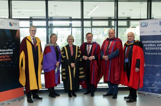 6 people in university gown posing for camera, 2 women, 4 men