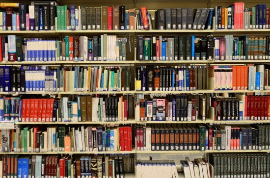 Library bookcases with various books 