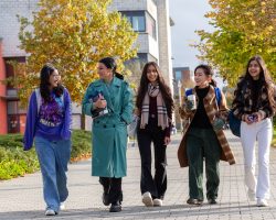 five female students walking together on a sunny day on maynooth campus